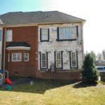 Partially renovated brick townhouse with Tyvek wrap