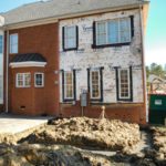 Brick townhouse under renovation with dirt pile