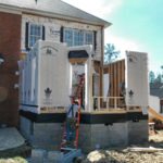 House addition under construction with workers