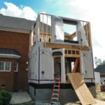 Brick house two-story addition under construction