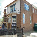 Two-story brick house with scaffolding