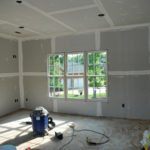 Unfinished room with drywall, shop vacuum, tools