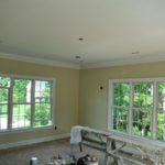 Unfurnished room with windows and painting supplies