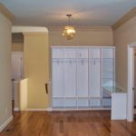 Entryway mudroom with white cubbies and hooks