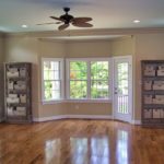 Empty living room with bay window, hardwood floors
