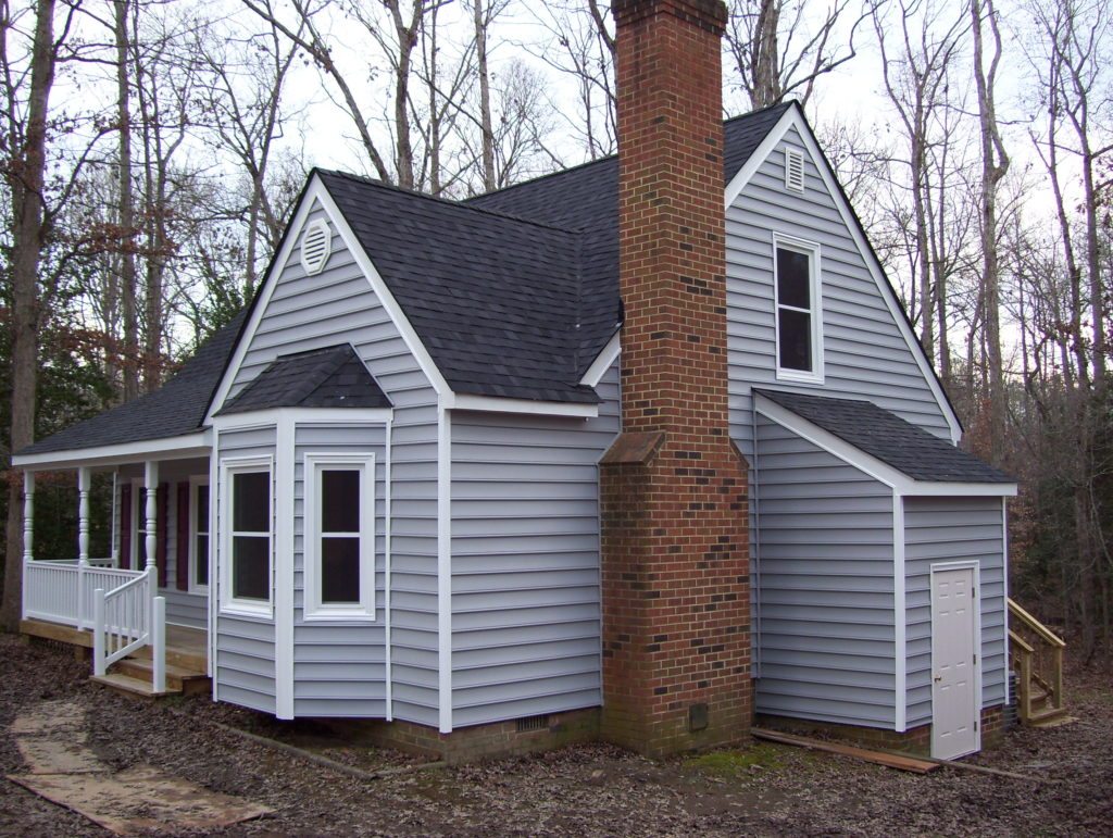 Gray house with porch and brick chimney