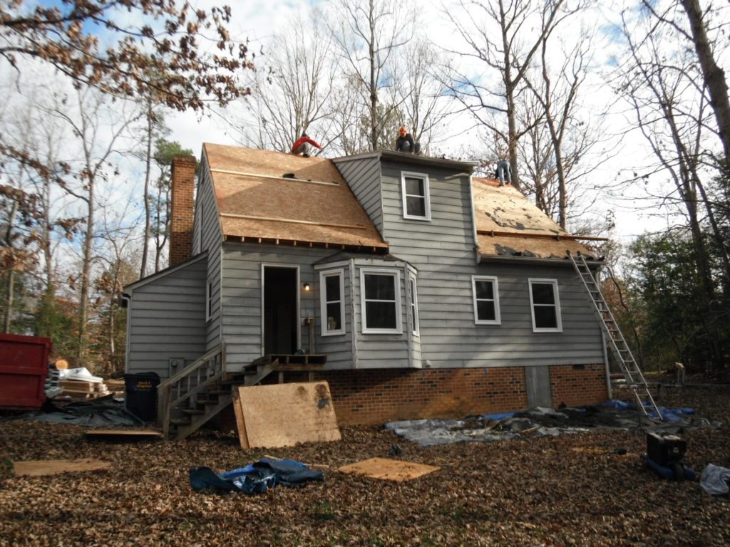 House undergoing roof repair with ladder