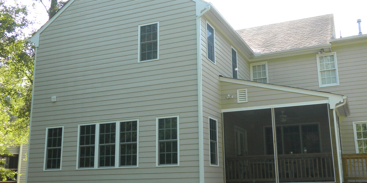 Beige two-story house with screened porch